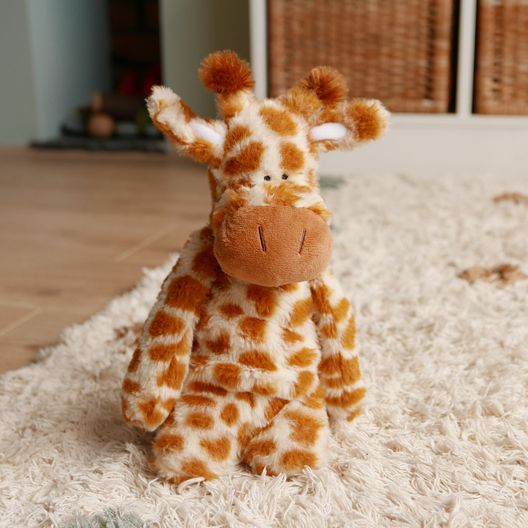 Giraffe plush toy on rug